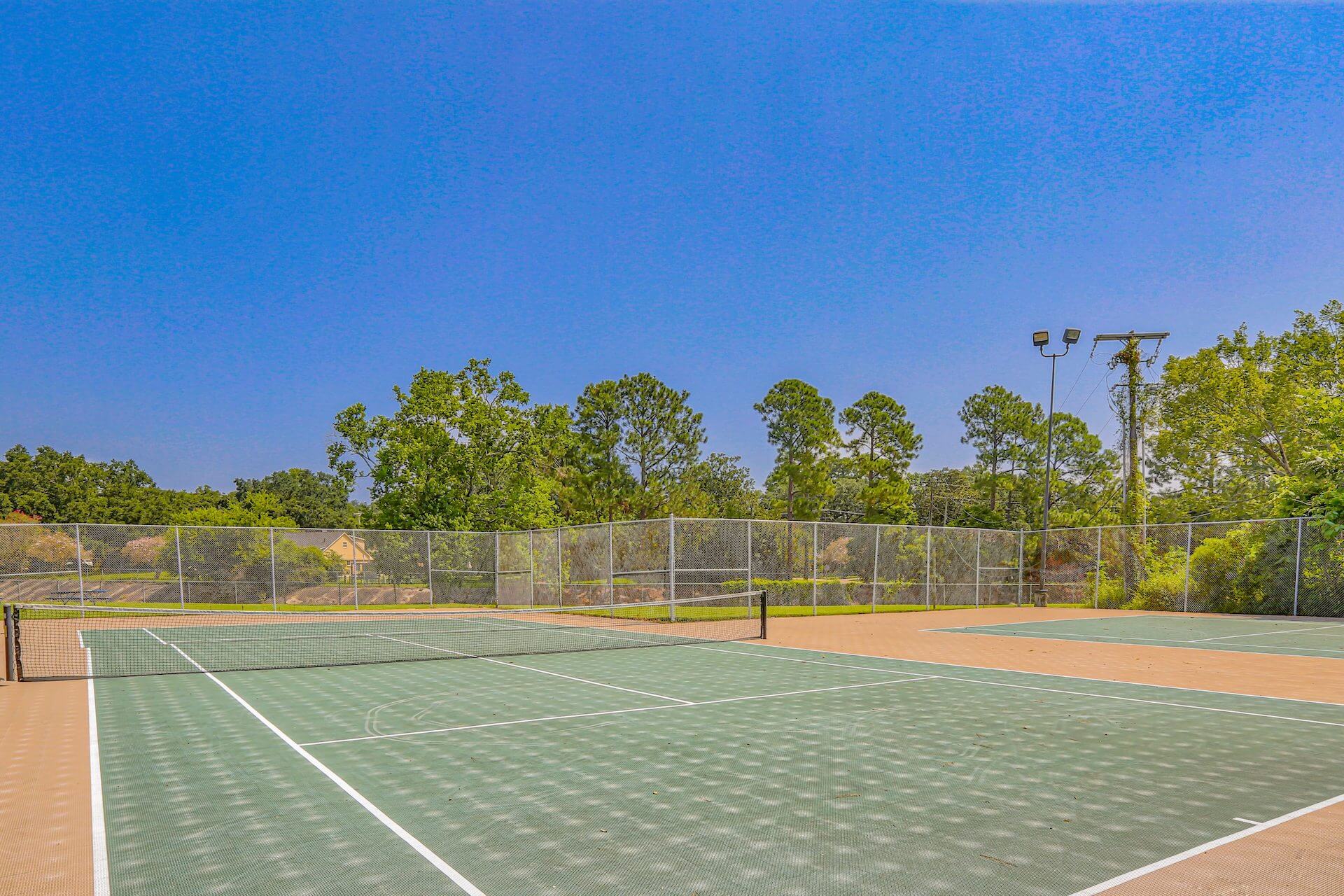 outdoor tennis courts located at fairway view apartments
